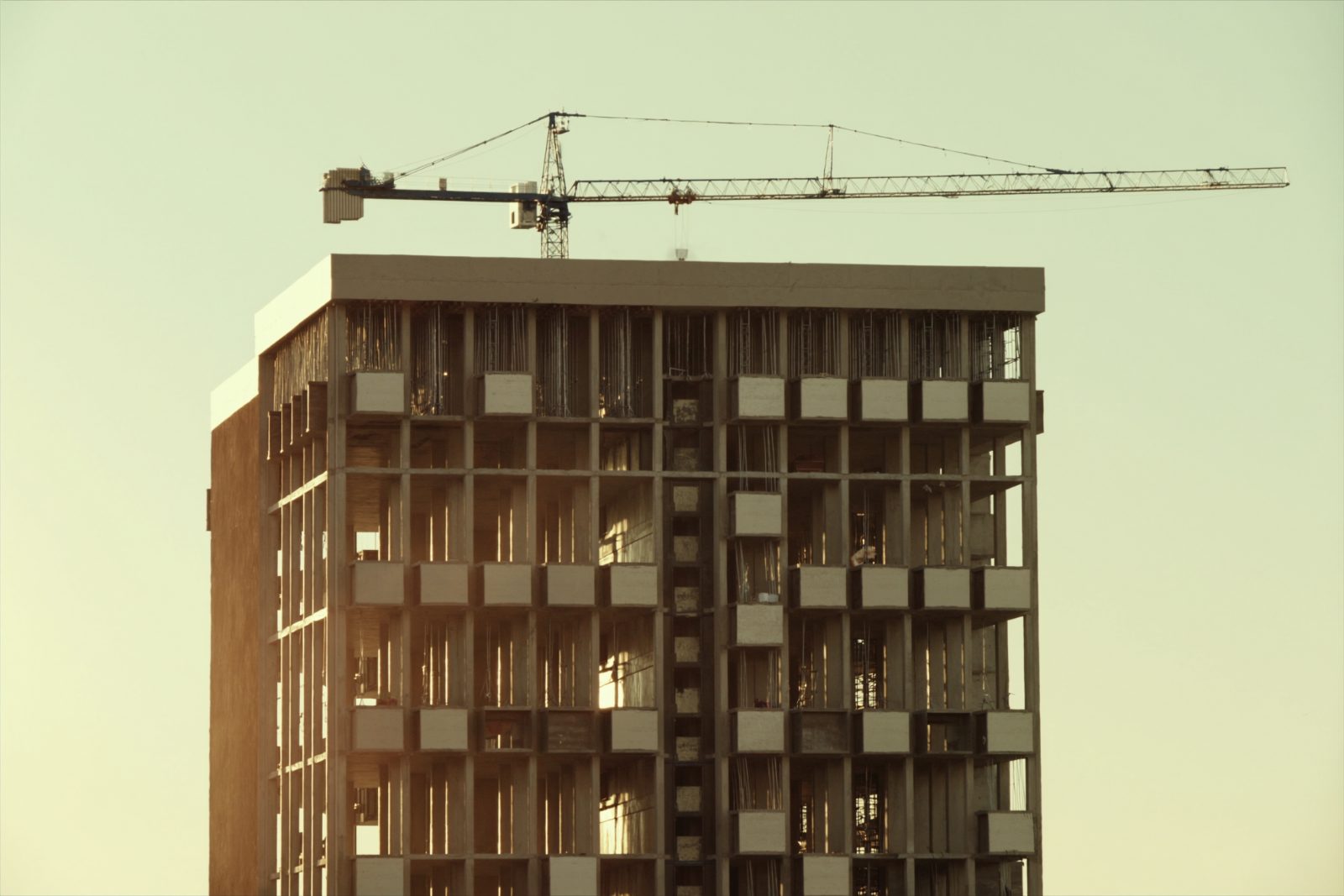 Residential tower under construction at golden hour